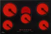 A top-down view of a black glass-ceramic cooktop with five heating elements that are glowing red. Náhled obrázku produktu