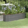 A raised garden bed filled with hydrangeas sits on a lawn next to a patio with a table and umbrella. Anteprima dell’immagine prodotto
