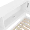 A close-up view of a white bed frame with a built-in shelf and power outlet. Podgląd zdjęcia produktu