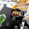 A person is cooking on a modern induction cooktop, with various icons highlighting features. Produktbild-Vorschau