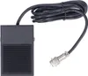 A black foot pedal switch with a ribbed surface and a coiled black cable ending in a silver connector. Náhled obrázku produktu