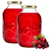 Two glass jars filled with red liquid, with a pile of mixed berries in the foreground. Podgląd zdjęcia produktu