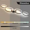 A modern LED ceiling lamp with four rings is shown, with a color temperature and brightness slider below it. Voir les images du produit
