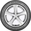 A close-up studio shot of a Dunlop Winter Sport 5 tire mounted on a silver alloy wheel. Podgląd zdjęcia produktu