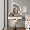 A vanity table with a round LED mirror, a stool, and decorative items in a bedroom setting. Produktbild-Vorschau