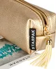 A close-up shot of a golden pencil case with a tassel. Anteprima dell’immagine prodotto