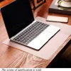 A laptop and a smartphone are placed on a desk with a transparent mat. Produktbild-Vorschau