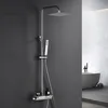A modern bathroom setting with a sleek shower system against a dark gray wall and a white bathtub in the background. Anteprima dell’immagine prodotto