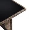 A close-up view of the corner of a rattan table with a black glass top. Produktbild-Vorschau