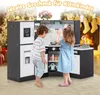 Two children are playing with a wooden toy kitchen in a festive, decorated room with a fireplace and Christmas tree. Náhľad obrázku produktu