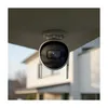 A security camera is mounted under an overhang, with a house in the background. Podgląd zdjęcia produktu