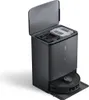 A black robot vacuum cleaner docked in its charging and emptying station, with the station's lid open revealing compartments for dust and water. Produktbild-Vorschau