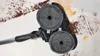 A close-up shot of a cleaning device with rotating brushes, cleaning up dirt and liquid. Voir les images du produit