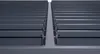 A close-up view of a gray aluminum pergola structure, showing the interlocking slats and support beams. Produktbild-Vorschau