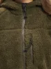 Close-up of a fuzzy green jacket with a zipper. Produktbild-Vorschau