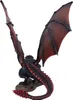 A figurine of a dragon is shown from behind, perched on a rock. Anteprima dell’immagine prodotto