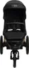 A black stroller is shown from the front. Náhled obrázku produktu