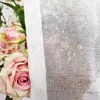 A close-up view of pink roses partially covered by a sheer white curtain. Podgląd zdjęcia produktu