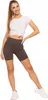 A woman is posing in athletic wear against a white background. Produktbild-Vorschau