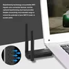 A close-up of a WiFi adapter plugged into a laptop, with text describing its features. Produktbild-Vorschau
