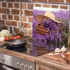 A kitchen counter with a stovetop and various ingredients, featuring a decorative glass panel with a lavender field image. Náhled obrázku produktu