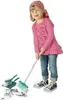 A young girl is sweeping with a toy broom and dustpan. Podgląd zdjęcia produktu