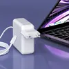 A white laptop charger and USB-C cable are shown next to a laptop. Podgląd zdjęcia produktu