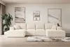 A modern living room with a large beige sectional sofa, abstract art on the wall, and a potted plant. Produktbild-Vorschau