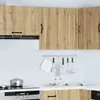 A close-up view of a kitchen corner with wooden cabinets, a range hood, and kitchen utensils hanging on a rack. Podgląd zdjęcia produktu