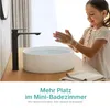 A young girl washing her hands at a modern sink in a bathroom. Produktbild-Vorschau