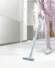 A person is vacuuming a hallway with a cordless vacuum cleaner. Podgląd zdjęcia produktu