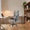 A modern home office setup with a desk, laptop, lamp, and a grey ergonomic office chair. Produktbild-Vorschau