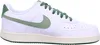 A side view of a white Nike Court Vision Low sneaker with green accents. Produktbild-Vorschau