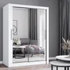 A white wardrobe with mirrored doors is shown in a room with a sofa and curtains. Náhľad obrázku produktu