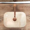 A top-down view of a beige rectangular sink with a copper faucet, mounted on a wooden surface. Podgląd zdjęcia produktu