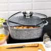 A speckled gray pot with a glass lid sits on a black stovetop, with ingredients and kitchen utensils nearby. Voir les images du produit