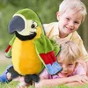 Two children are playing with a plush parrot toy on the grass. Anteprima dell’immagine prodotto