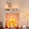 A white fireplace console decorated with candles and a deer head. Produktbild-Vorschau