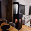 A modern living room with a fireplace, sofa, and dining table. Produktbild-Vorschau