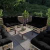 An outdoor patio set with pallet furniture and black cushions. Voir les images du produit