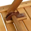 A close-up view of a wooden table's folding mechanism. Produktbild-Vorschau