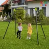 Two children are swinging on a swing set in a grassy yard in front of a house. Produktbild-Vorschau