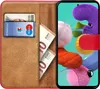 A book-style phone case is open, showing a card and some euro banknotes inside. A smartphone is attached to the case, displaying a colorful background. Voir les images du produit