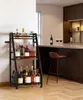 A wine rack filled with bottles of wine and other beverages is placed next to a kitchen counter with bar stools. Produktbild-Vorschau