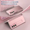 A rose gold phone case with a stand and pen holder is displayed on a pink and white background. Anteprima dell’immagine prodotto