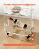 A clear acrylic rolling cart with a bottle of wine and glasses on it, shown on a wooden floor. Produktbild-Vorschau