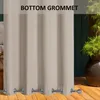 A close-up of beige outdoor curtains with grommets at the bottom, set against a backdrop of greenery and a wooden deck. Voir les images du produit