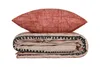 A folded duvet and pillow with a red patterned pillow on top of a beige duvet with a black and red pattern. Náhľad obrázku produktu