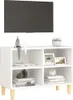 A white TV stand with wooden legs, decorated with small figurines, framed pictures, books, and a plant. Podgląd zdjęcia produktu