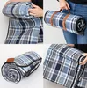 Collage of a rolled-up picnic blanket with leather straps, showing different angles and how it's carried. Anteprima dell’immagine prodotto